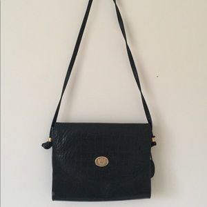 Vintage black handbag with flap and gold emblem